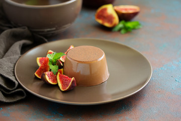Delicious home-made chocolate dessert Panna cotta. Cream-caramel, caramel custard, with figs.