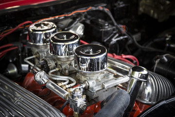 Under the Hood View of Restored Vintage Automobile Engine with Tri-Power Show-Chrome Carburetors