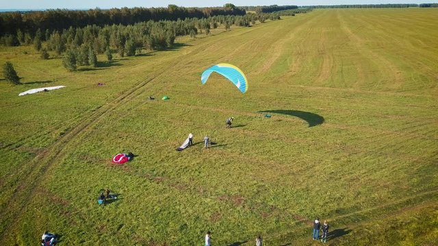 Paraplane, paraglider in the air aerial shot. Extreme life. A man is flying on a paraglider