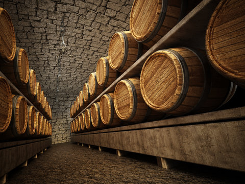 Stocked wine barrels across two sides of corridorof a wine cellar