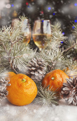 Christmas balls with fir branches and glasses of champagne