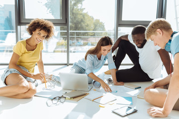 Fototapeta premium Cheerful international students working on the university project