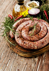 raw beef sausages on a cast-iron pan,  selective focus