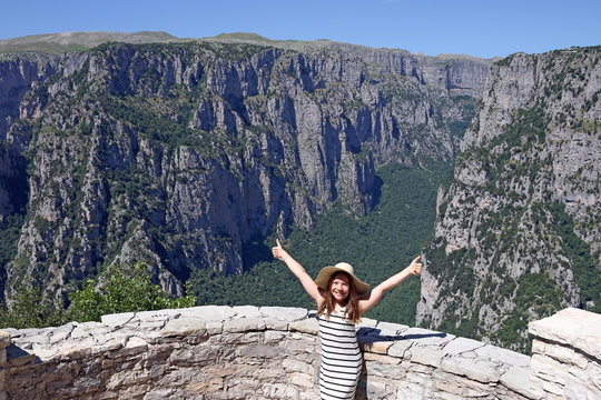 happy little girl with thumbs up on the viewpoint Vikos gorge Greece