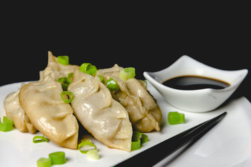 Japanese gyoza dumplings with soy sauce and chopsticks