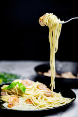 Spaghetti with shrimps and cream sauce  twirled on fork