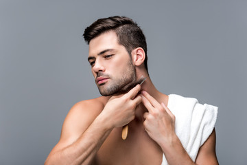 man shaving with straight razor