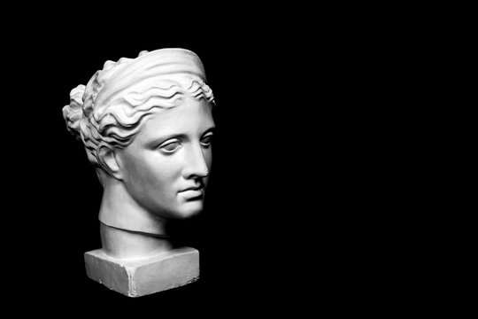 Marble head of young woman, ancient Greek goddess bust isolated on pink background with space for text.