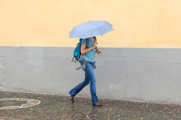 Mysterious girl walking with umbrella