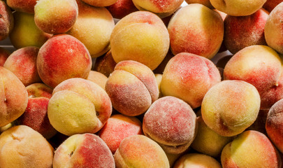 Bunch of fresh ripe peaches as a background