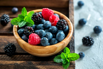 Fresh summer berries, raspberry, blueberry, blackberry in a bowl, raw vegan eating