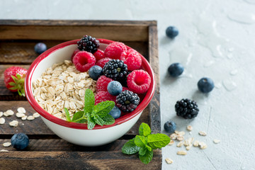 Healthy oatmeal muesli breakfast, muesli with berries, vegan, diet and detox concept, clean eating, vitamin food, healthy lifestyle