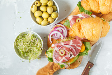 croissant sandwich with ham, olives and vegetable