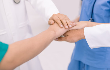 Doctors and nurses in a medical team stacking hands,teamwork medical concept