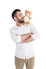 Man carrying teddy bear on shoulder