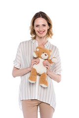 smiling woman holding teddy bear