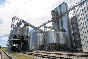 Fototapeta na wymiar Agricultural Silos. Metal grain facility with silos.