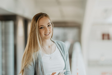 pretty young woman with long hair holding smartphone