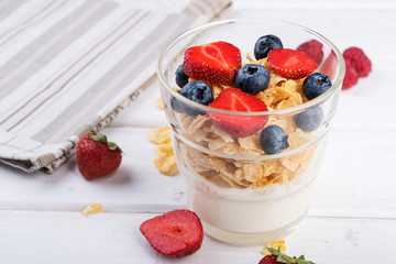Healthy breakfast,  yogurt with flasks and berries, selective focus