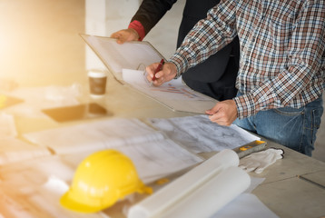 Team of Businessman /engineering in construction renovate building site. Engineer/architect inspection workplace for project.Teamwork construction engineer,business and architecture concept. 