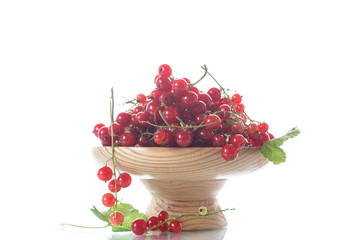 Ripe red currant in a wooden vase