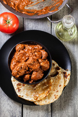 Chicken tikka masala served with bread naan