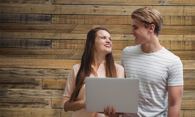 Composite image of smiling colleagues looking at each other