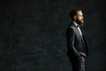 Bearded young businessman standing on modern loft office