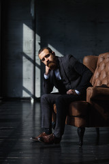 Bearded young businessman in modern loft office.