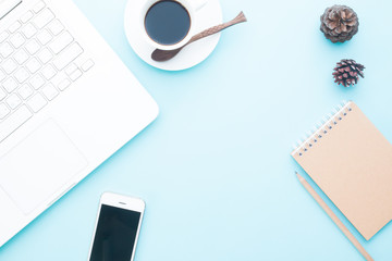 Overhead view of modern work space with laptop and mobile device. Online and business marketing on pastel color background