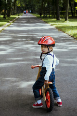 Little boy on the bike in the sunlight 