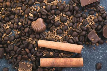 Sweet still life. Coffee beans, chocolate bars and cinnamon sticks.