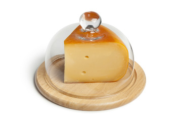Piece of Dutch Gouda cheese covered with a glass hood