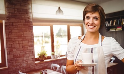 Composite image of smiling waitress holding a cup of coffee