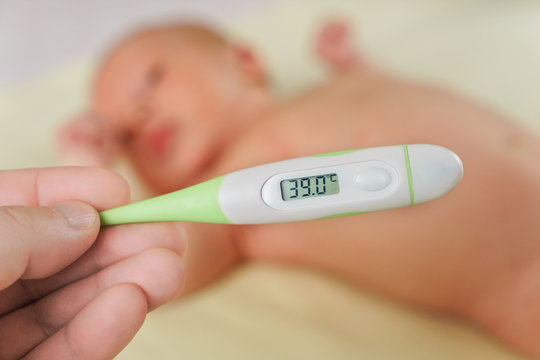 Thermometer With High Temperature And Sick Newborn Child