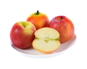 red apple in white plate isolated on white background