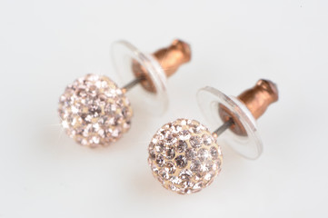 Beautiful sparkling earrings on white background