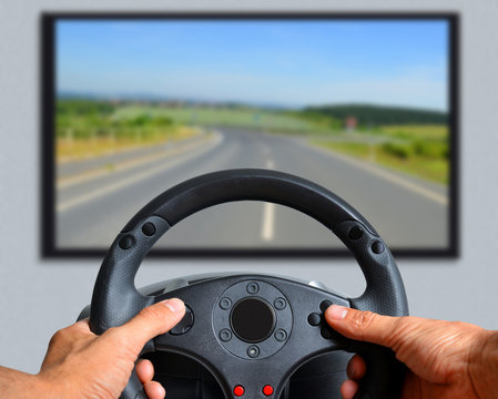 Hands Holding Gaming Steering Wheel.  The Gamer Is Playing A Car Race.