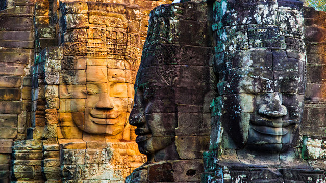 Stone murals and statue Bayon Temple Angkor Thom. Angkor Wat the largest religious monument in the world. Ancient Khmer architecture.  Location: Siem Reap, Cambodia.