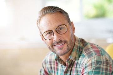 Fototapeta premium Mature man with eyeglasses relaxing at home