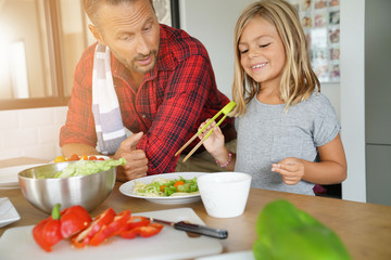 Father and daughter cooking pasta dish together