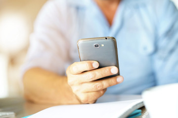 Closeup of male's hands holding smartphone