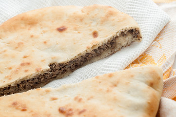 round pie with filling on a table