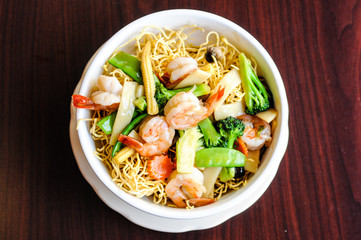 Goey See Me, Crispy egg noodle topped with broccoli, mushroom, bamboo shoot, peapod, carrot, baby corn in delicious gravy sauce