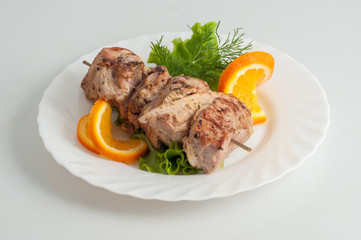 Beef pork barbecue kebab on skewer on a white plate