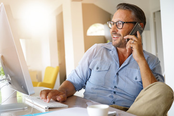 Home-office businessman talking on phone