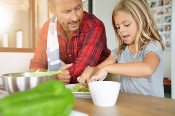 Father and daughter cooking pasta dish together © goodluz