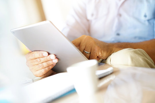 Closeup of digital tablet used by businessman