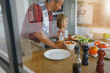 Father and daughter cooking pasta dish together