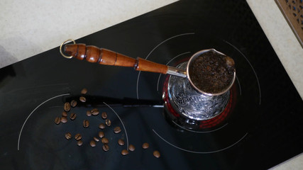A delicious aromatic coffee is on the stove brewed.